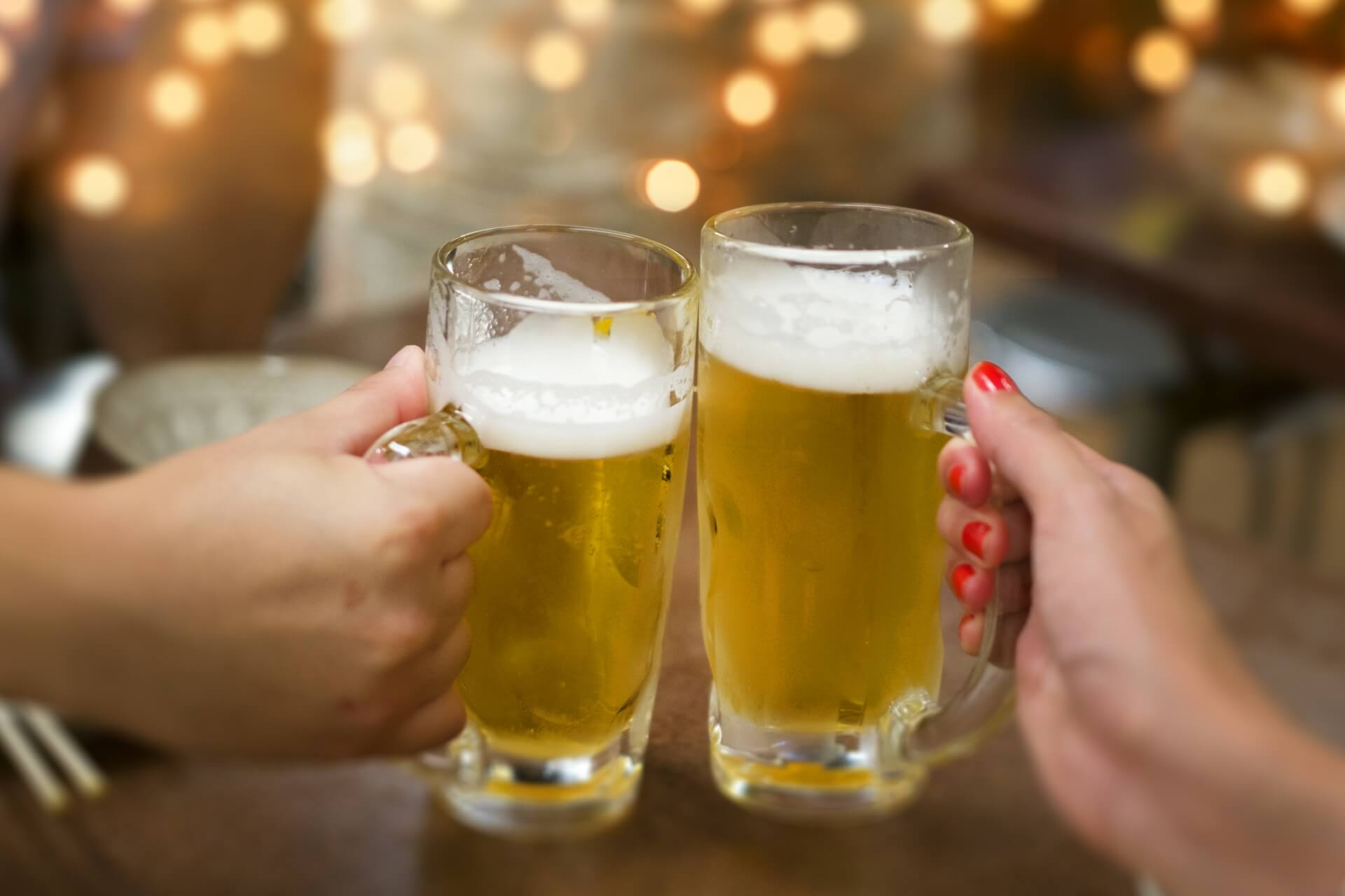 ビールジョッキで乾杯する2人の手